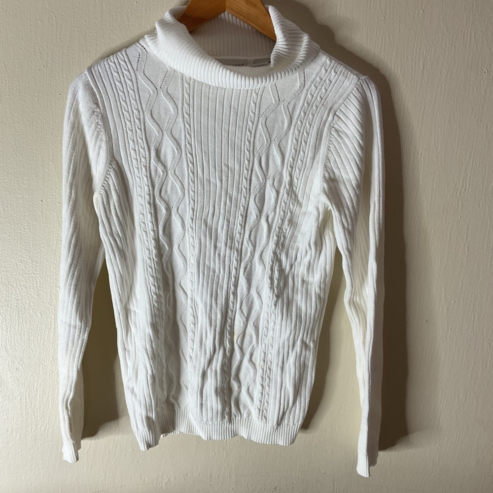 Kim Roger’s white lined turtleneck